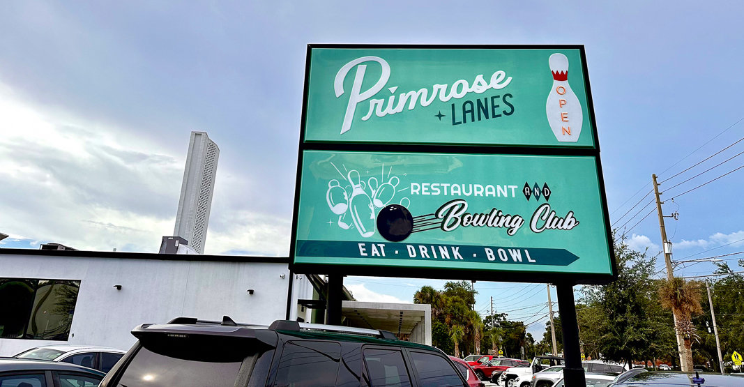 teal primrose lanes bowling sign over white building